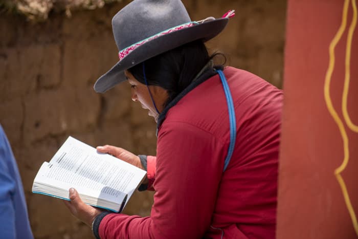 A woman looks over a book during a break in the schedule of a training workshop in the community of Quechapampa. The two day workshop run by ATEK was designed to help lay Pastors in Bible exegesis. Often they are asked to serve as pastors without any formal training and help in Bible exegesis.